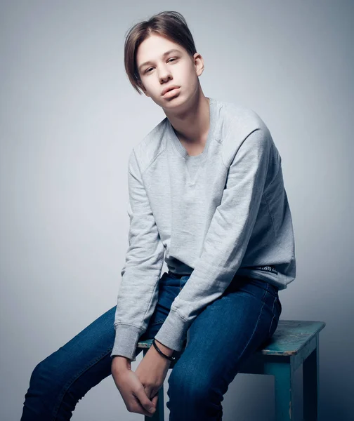 Fashion and people concept: stylish trendy young man dressed in casual clothes posing in over gray background — Stock Photo, Image