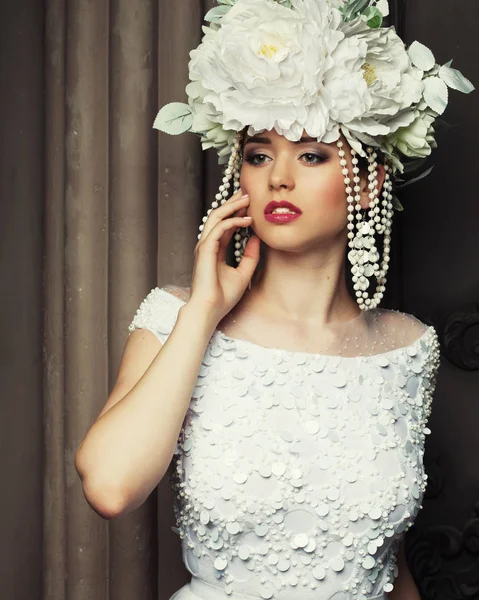 Joven hermosa mujer con vestido blanco y corona de flores de pie en la habitación del palacio . — Foto de Stock