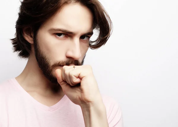 Young handsome male with beard, mustache and trendy hairdo, wears casual pink t-shirt — Stock Photo, Image