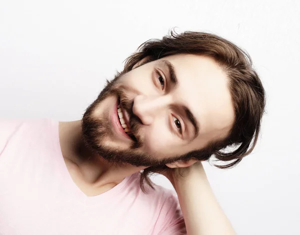 Young handsome male with beard, mustache and trendy hairdo, wears casual pink t-shirt — Stock Photo, Image