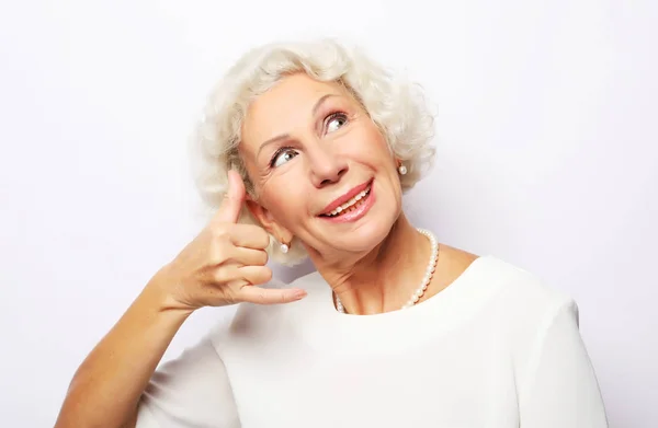 Call me, please. Lifestyle, emotion and people concept: Elderly happy woman is gesturing to call her with a hand — Stock Photo, Image