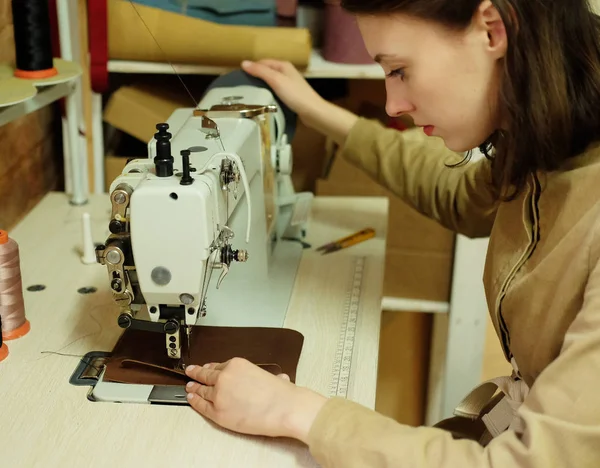 Gros plan sur la jeune femme couture sac à main en cuir — Photo