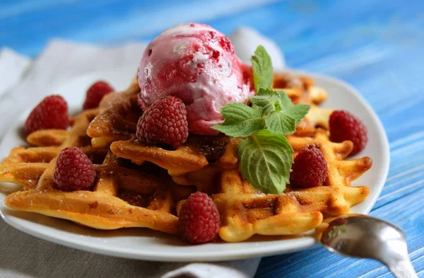 Plate of belgian waffles with ice cream and fresh berries over blue wooden background, top view — Stock Photo, Image