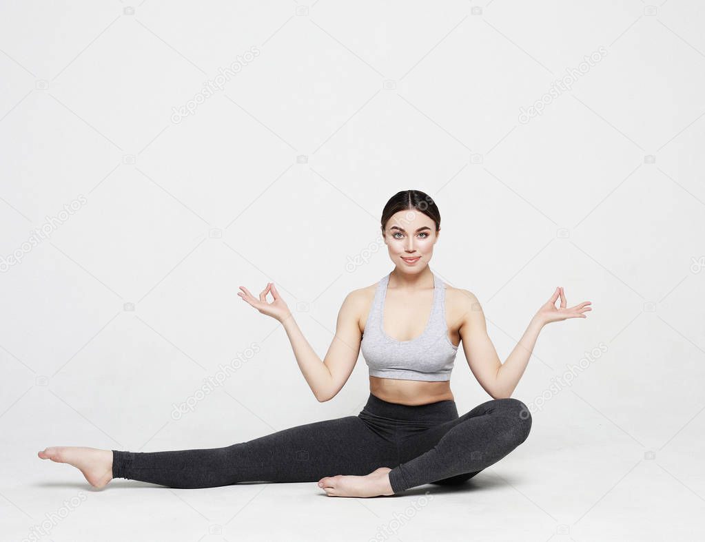 sport, yoga and people concept - lovely young woman doing yoga, sports exercises for relaxation and meditation