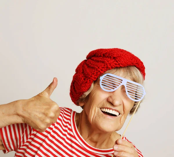 Lifestyle, emotion and people concept: funny grandmother with fake glasses, laughs and ready for party — Stock Photo, Image