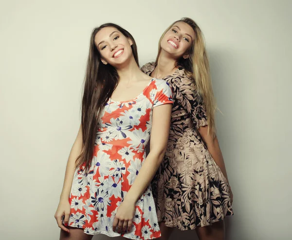 Fashion and people concept - two stylish sexy girls best friends wearing dress — Stock Photo, Image
