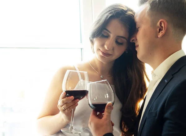 Young newlywed couple drinking wine and smiling at their happiness, romance and tenderness — Stock Photo, Image