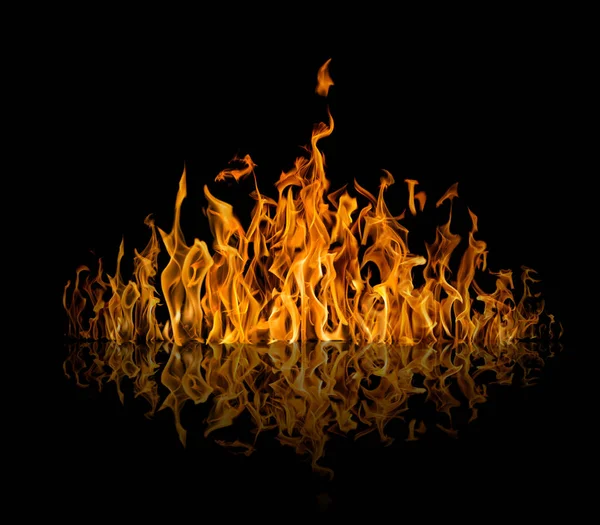 Yellow dark large flame with reflection on black — Stock Photo, Image