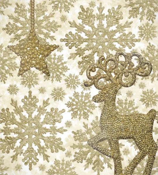 deer and star on background from gold snowflake shape decorations