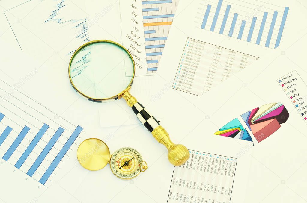 Compass and magnifying glass on the market reports