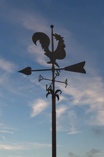 Iron weathercock in front of blue sky — Stock Photo, Image