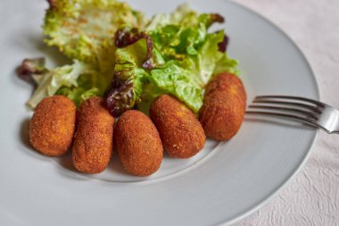 İspanyol restoranında yeşil salata ve tavuk kroket