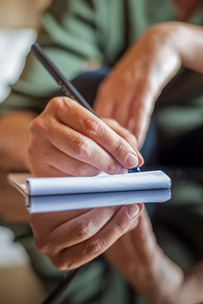 Woman hand writing anything on a paper — Stock Photo, Image