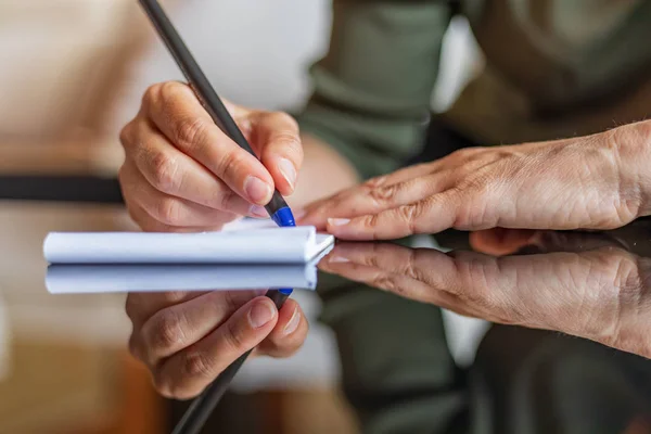 Woman hand writing anything on a paper — Stock Photo, Image