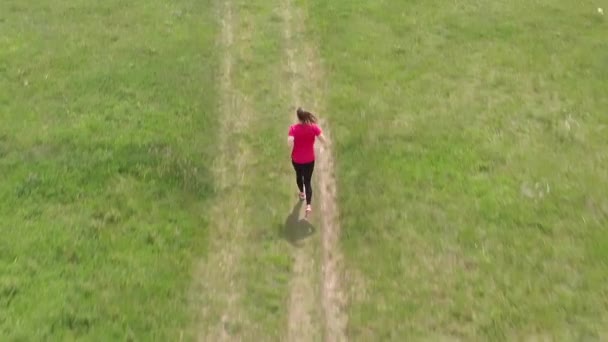 草原で走るスポーティなティーンエイジャー 空中映像 — ストック動画