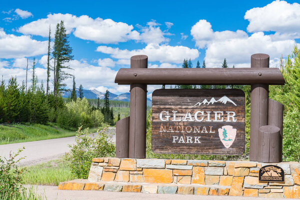 WEST GLACIER, MT - JUNE 26, 2018: Welcome sign at the entrance to Glacier National Park, Montana