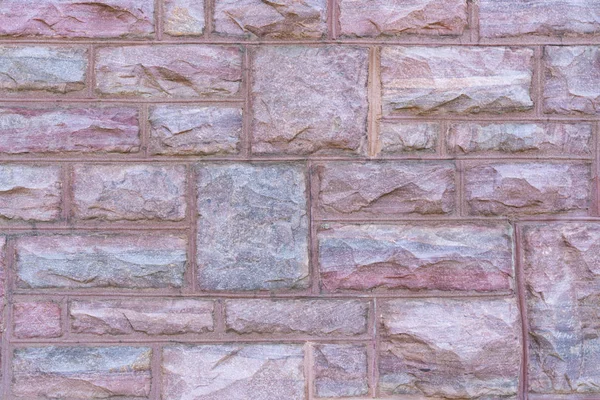 Granite block wall background on building facade