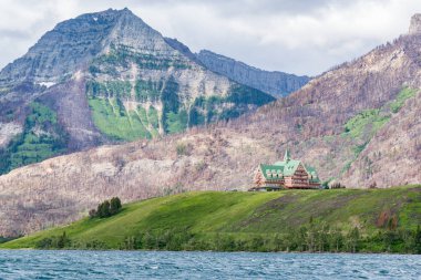 WATERTON, CANADA - JULY 1, 2018: The historic Prince of Wales Hotel in Waterton Lakes National Park, was built in 1927 clipart