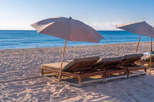 Lounge chairs & umbrellas lined up on South Beach, Florida