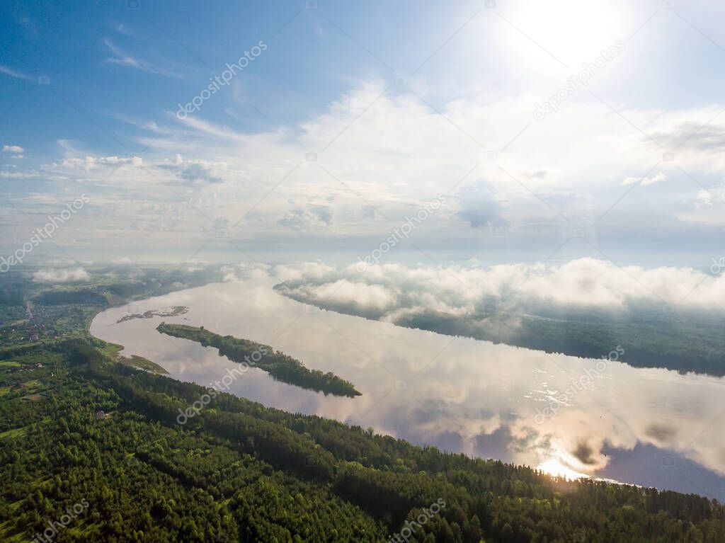 Kama river at sunrise and green forest in Russia taken from above using a drone