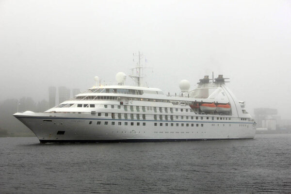 Velsen, the Netherlands - June 2nd 2018: Star Breeze on North Sea Canal in misty weather, owned by Windstar Cruises