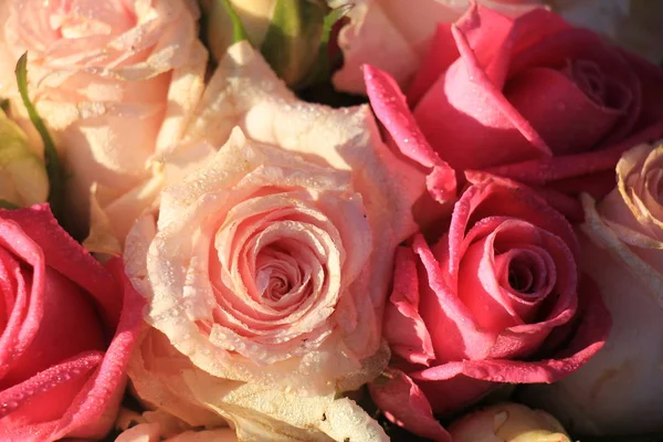 Mixed pink roses in a floral wedding decoration