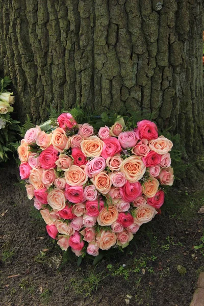 Sympathy flowers near a tree