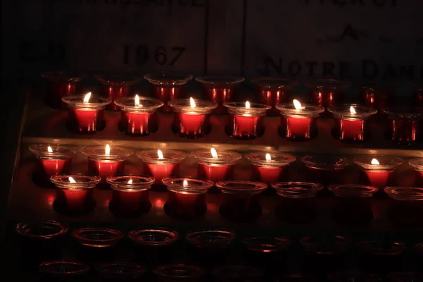 Burning votive candles in a Roman Catholic church in Marseille, France