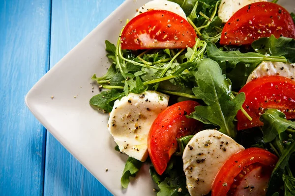 Caprese Salad Mozzarella Tomatoes Arugula White Plate Blue Wooden Background — Stock Photo, Image