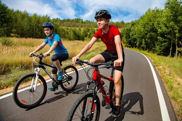 田舎で自転車に乗って健康な若いカップル — ストック写真