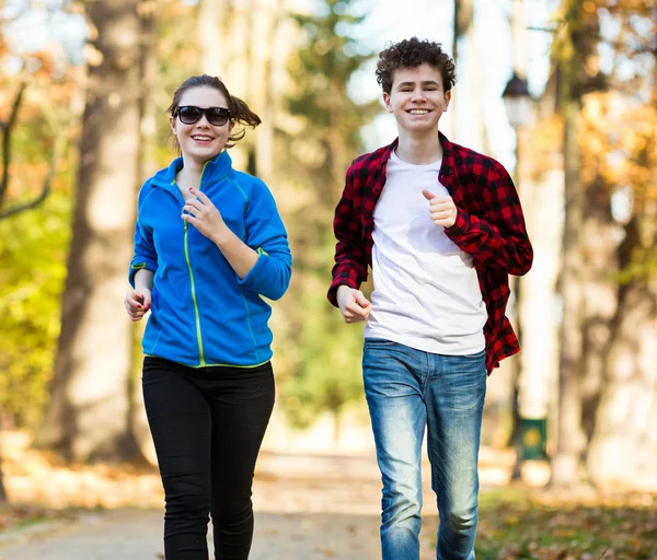 Happy Teenagers Jogging Together Autumn Forest — Stock Photo, Image