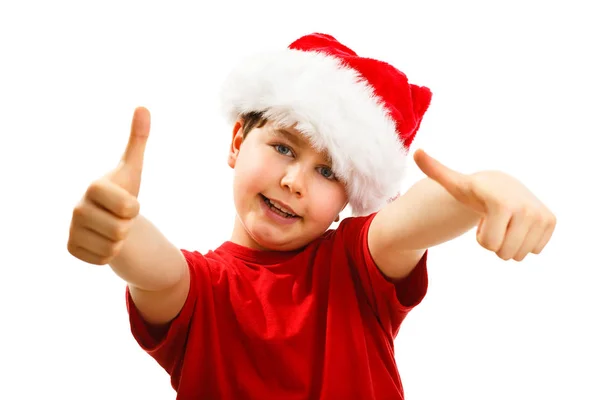 小男孩在圣诞老人帽子显示拇指在白色背景被隔绝了 — 图库照片
