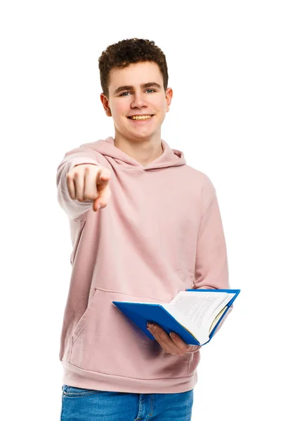 Menino Segurando Livro Apontando Com Dedo Isolado Fundo Branco — Fotografia de Stock