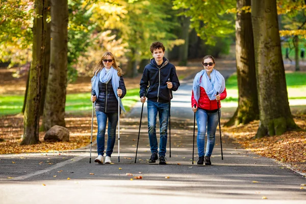 Family Three Walking Using Tourist Sticks City Park — Stock Photo, Image