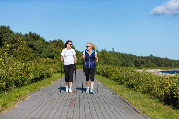 Two Middle Aged Women Walking Seaside Tourist Sticks — Stock Photo, Image