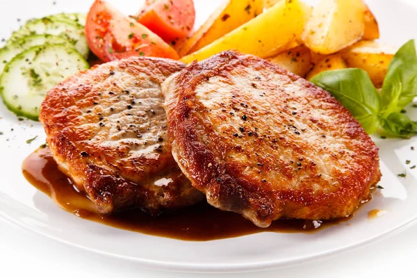 Roasted Pork Cutlets Potato Wedges Tomatoes Cucumbers Served White Plate — Stock Photo, Image