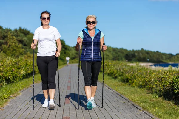 Zwei Frauen Mittleren Alters Gehen Mit Touristenstöcken Meer Spazieren — Stockfoto