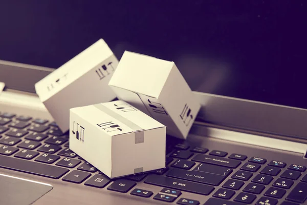 delivery packaging boxes on laptop keyboard