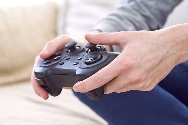 man holding joystick controllers while playing video games at home