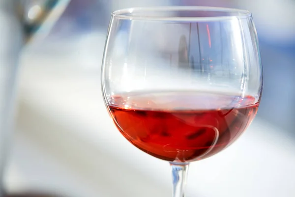 glass of rose wine in bright sunlight, close-up