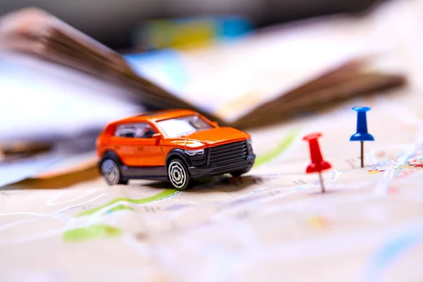 small toy car on map, travel concept