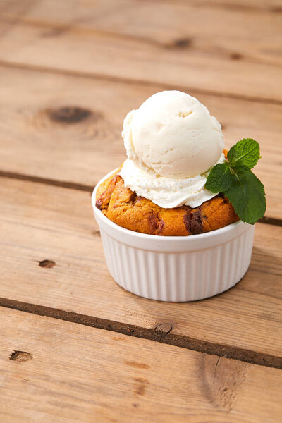 pumpkin cake with ice cream in white bowl, close-up 