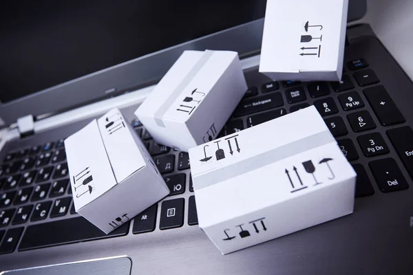 delivery packaging boxes on laptop keyboard