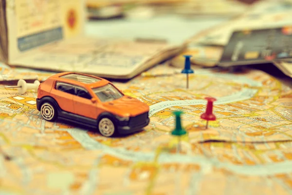 small toy car on map, travel concept