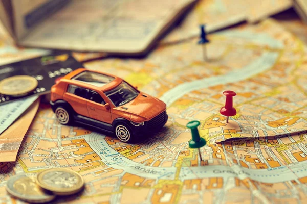 small toy car on map, travel concept