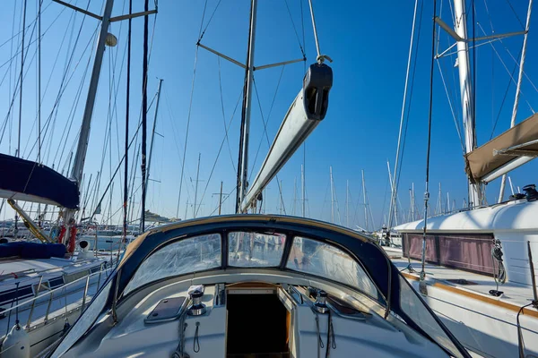 Luxury yacht with tackle at harbor with blue sky on background