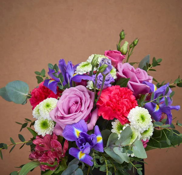 nice bouquet of flowers on beige background, close-up