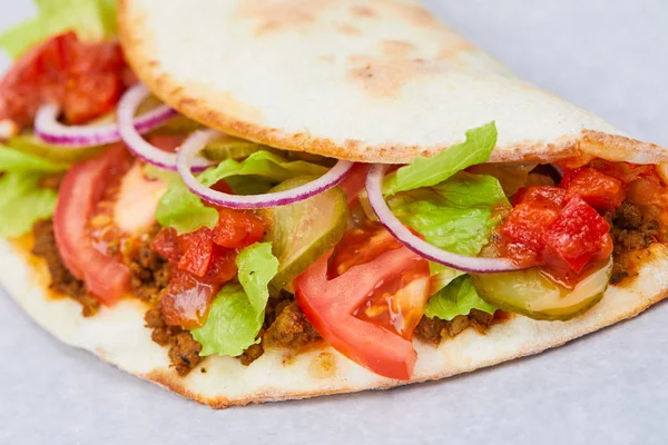 sandwich wrap with meat and vegetables, close-up