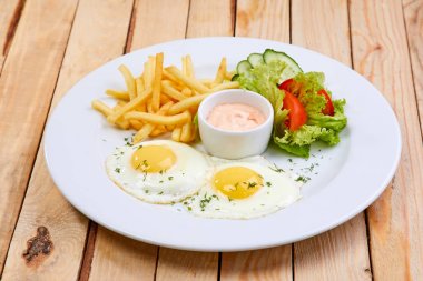salata ve beyaz tabakta patates kızartması ve kızarmış yumurta ile, kafe kavramı kahvaltı 