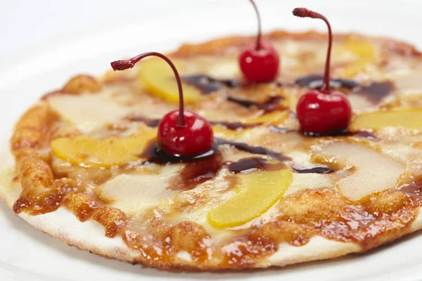 sweet pizza with cherries and chocolate, close-up